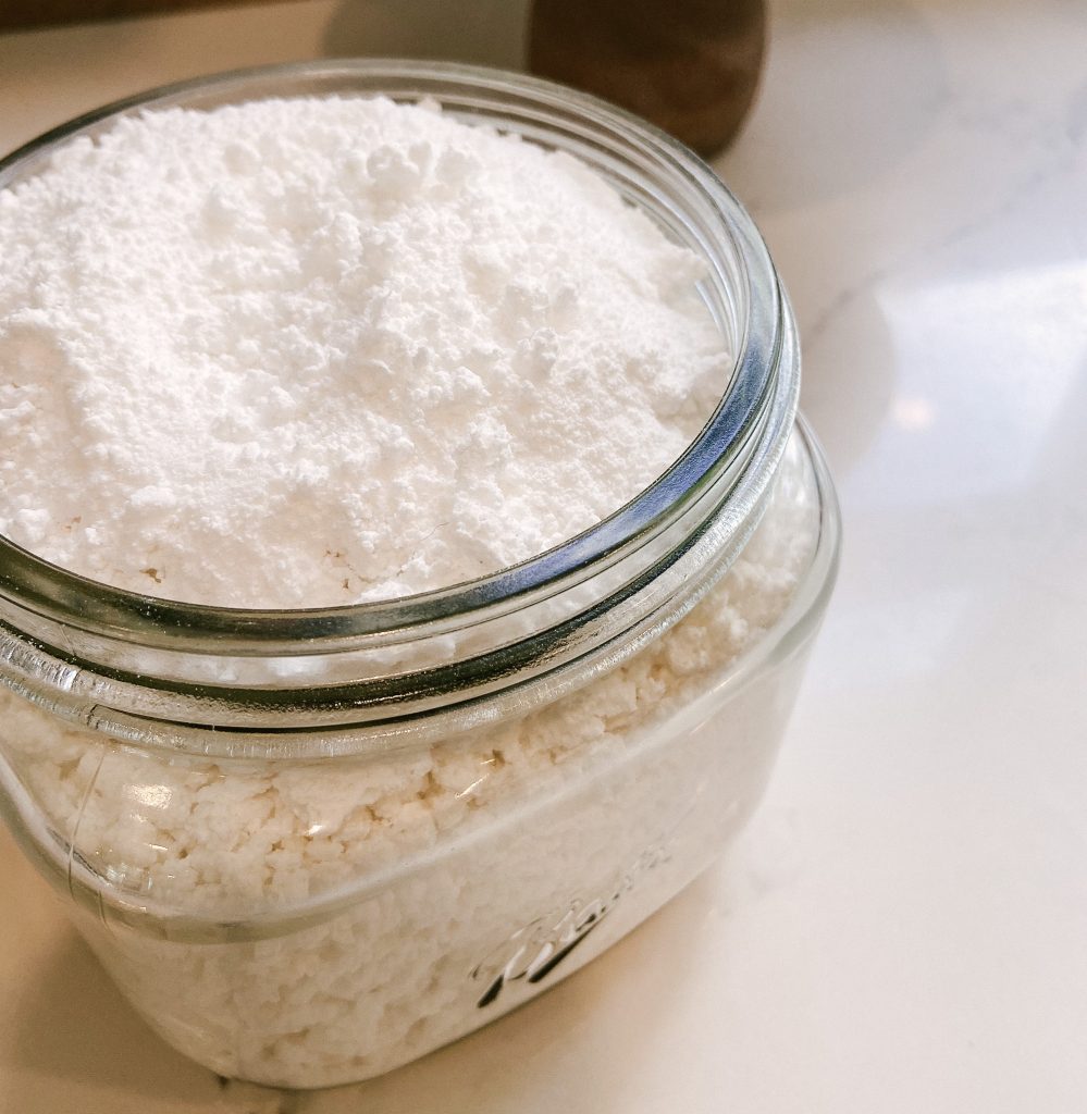 homemade dishwasher powder in glass jar on kitchen counter