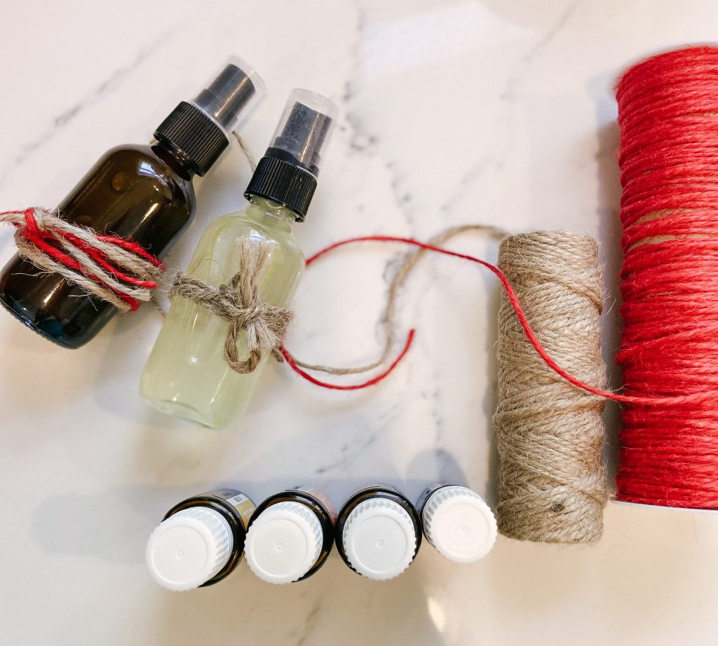 natural room spray glass bottles, twine and essential oils on counter