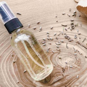 best wrinkle release spray in glass bottle on wood counter with dried lavender