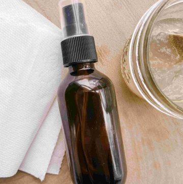 regular toilet paper, amber glass spray bottle with DIY toilet paper spray and aloe in glass jar