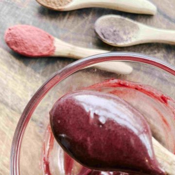 diy blush cream on wooden spoon, glass bowl and natural colorants on wooden spoons