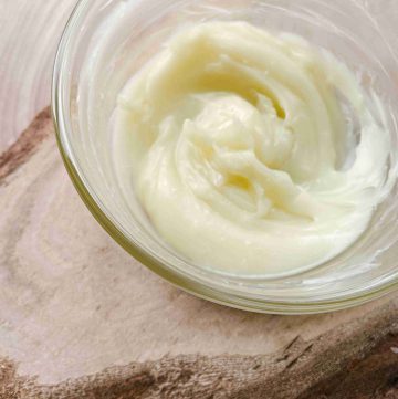 natural nose balm and paw butter for dogs in glass bowl on wood counter